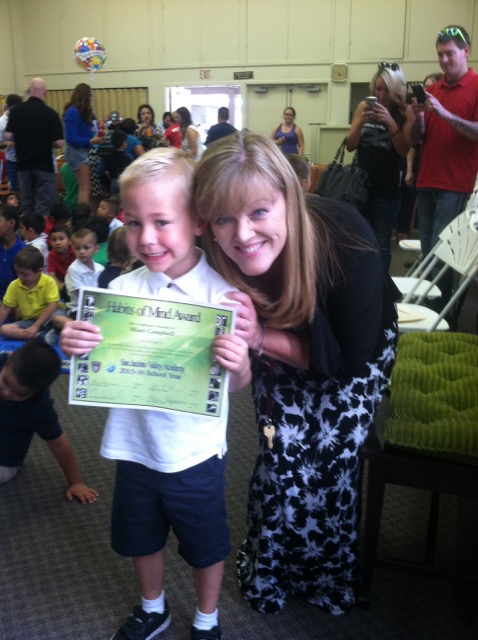 A photo of Hiatt with his teacher and an award he earned